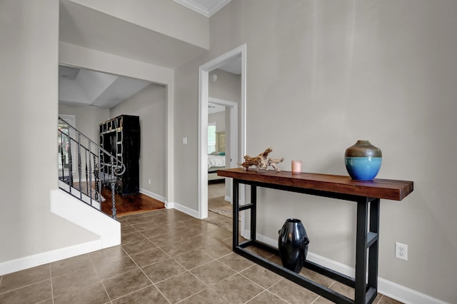 foyer featuring tile patterned flooring and crown molding