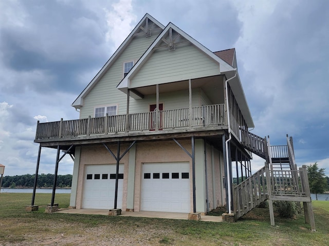 rear view of house with a garage and a lawn