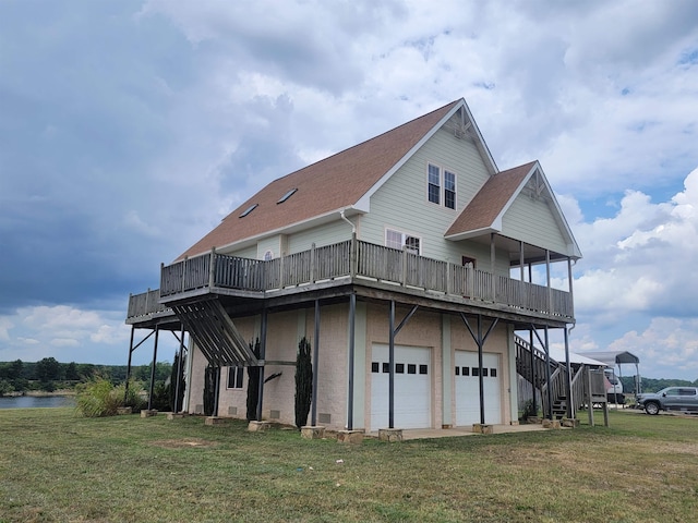 back of property featuring a garage, a yard, and a deck