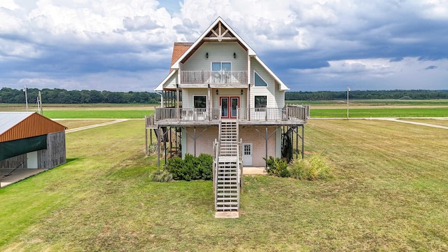 view of front of home with a balcony, a rural view, a deck, and a front yard