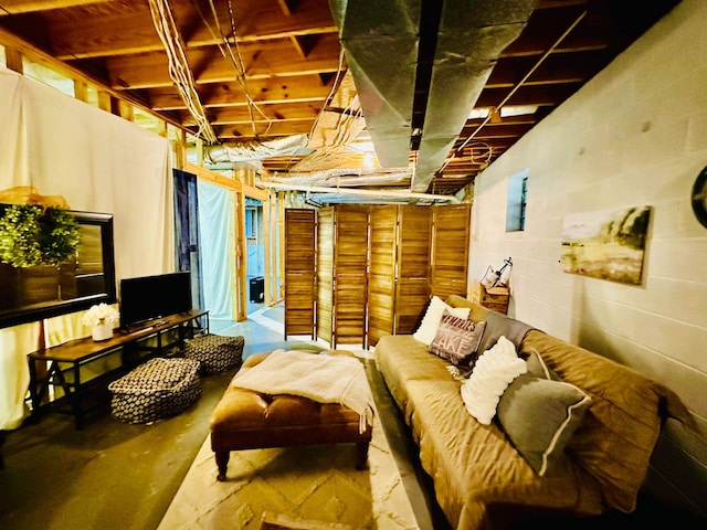 interior space featuring concrete block wall and concrete floors