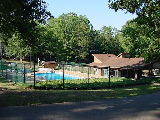 exterior space featuring fence and a pool