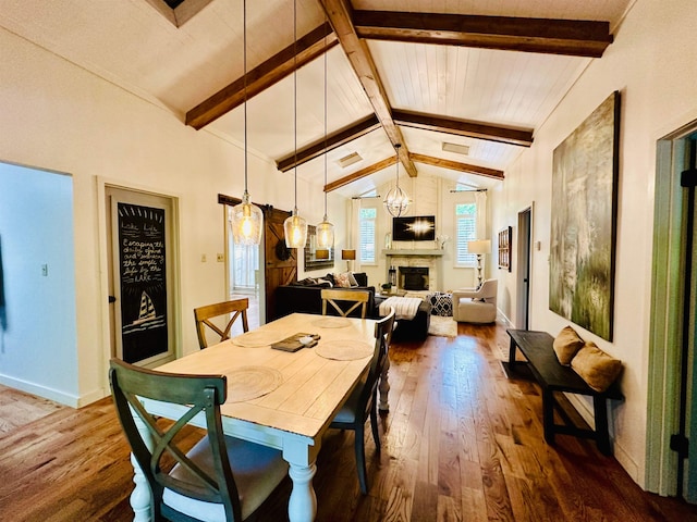 dining area with dark wood finished floors, a fireplace, vaulted ceiling with beams, and baseboards