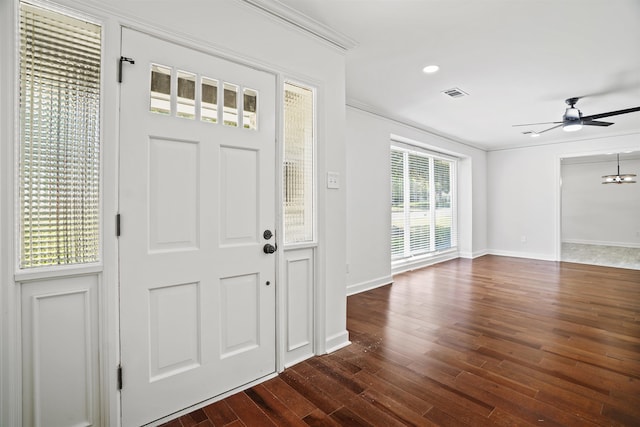 foyer featuring ceiling fan, dark wood-type flooring, and crown molding