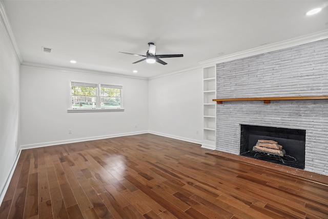 unfurnished living room with ceiling fan, built in shelves, dark hardwood / wood-style floors, and crown molding