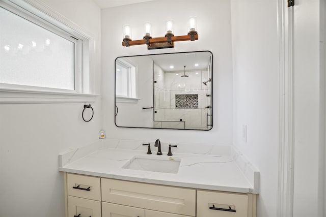 bathroom with vanity and a shower