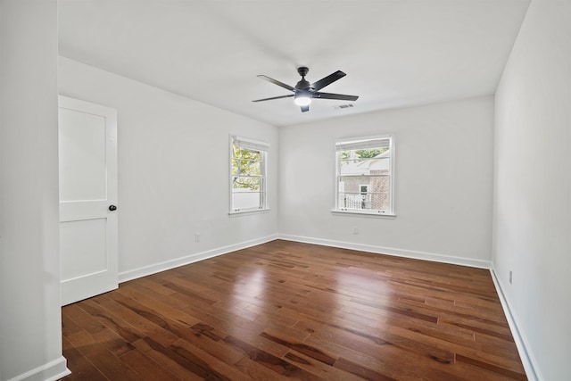 empty room featuring ceiling fan and dark hardwood / wood-style flooring