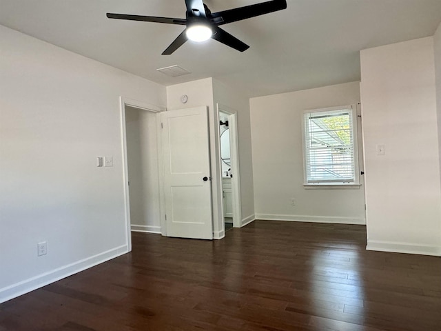 spare room with ceiling fan and dark hardwood / wood-style floors