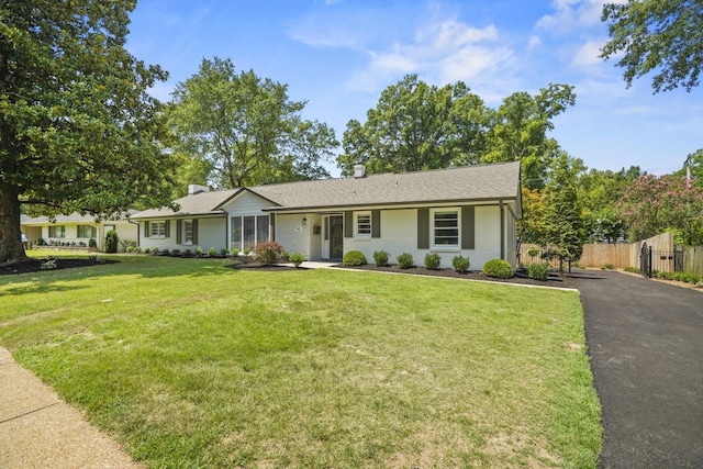 ranch-style home with a front yard