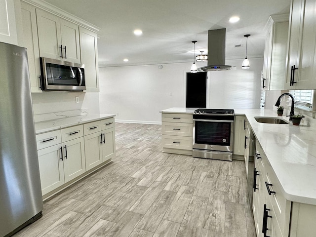 kitchen featuring hanging light fixtures, sink, light stone counters, island range hood, and stainless steel appliances