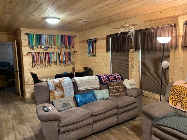 living room with wood walls, hardwood / wood-style flooring, and wood ceiling