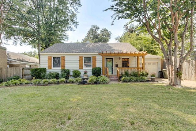 view of front of property featuring a garage and a front lawn