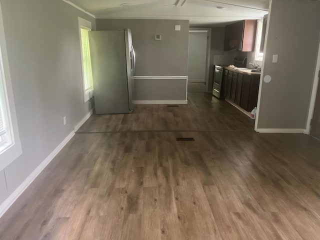 kitchen featuring sink, appliances with stainless steel finishes, crown molding, and dark hardwood / wood-style floors