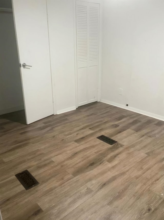 unfurnished bedroom with hardwood / wood-style floors