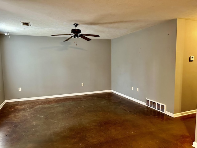 unfurnished room with ceiling fan and a textured ceiling