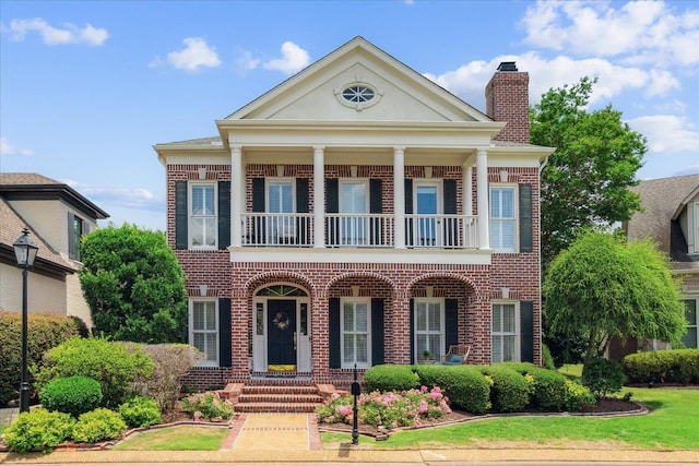 greek revival house with a balcony