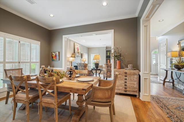 dining area featuring light hardwood / wood-style floors and ornamental molding