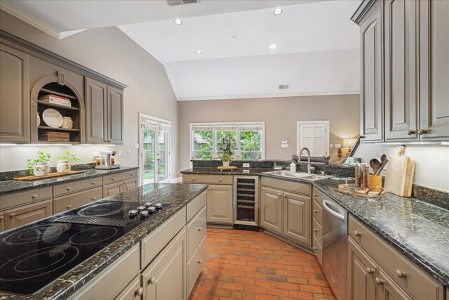 kitchen with dark stone counters, black electric stovetop, sink, dishwasher, and wine cooler