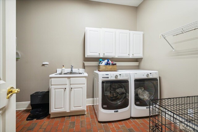 washroom featuring washer and clothes dryer, sink, and cabinets