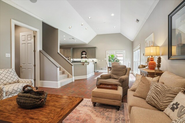 living room with crown molding and high vaulted ceiling