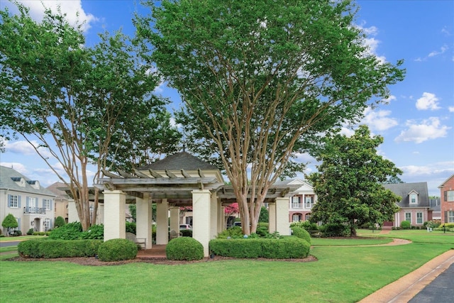 neoclassical / greek revival house featuring a pergola and a front yard