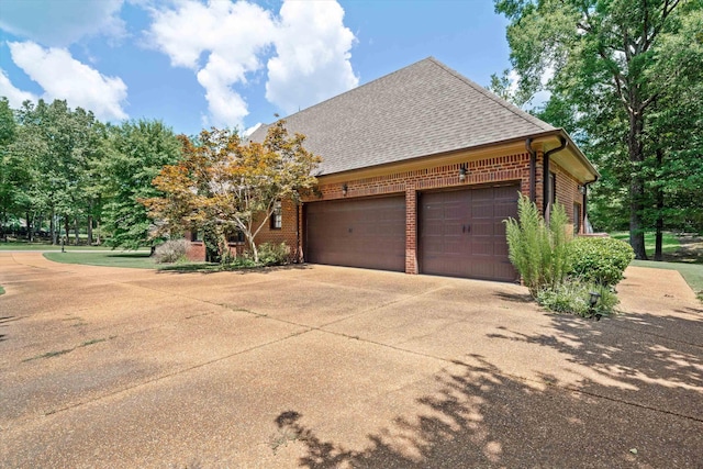 125 Millbury Ln, Eads, TN 38028 - exterior space featuring a garage, brick siding, roof with shingles, and driveway