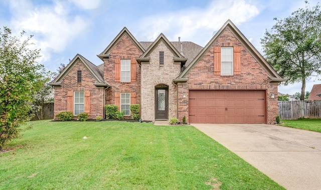 view of front of home featuring a garage and a front lawn