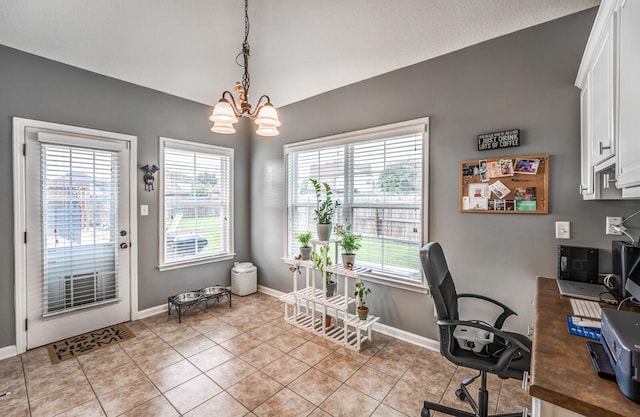 home office with light tile patterned floors and an inviting chandelier