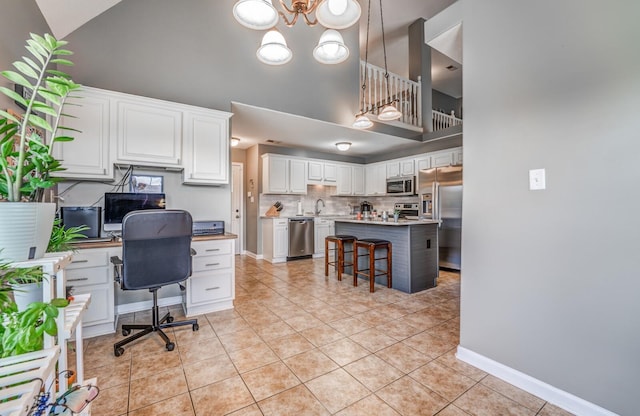 office area featuring light tile patterned flooring, sink, a chandelier, and high vaulted ceiling