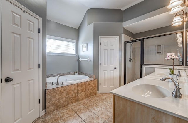 bathroom featuring vaulted ceiling, vanity, independent shower and bath, and tile patterned flooring