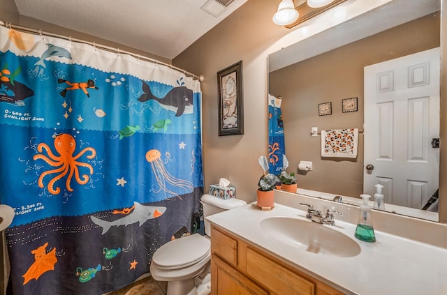 bathroom with vanity, a shower with curtain, tile patterned floors, and toilet