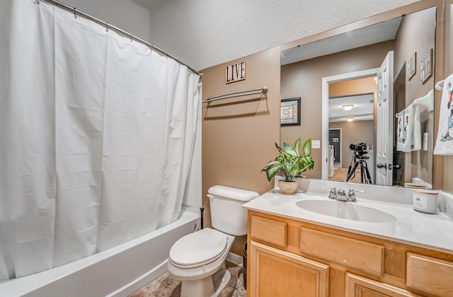 full bathroom with tile patterned floors, toilet, a textured ceiling, vanity, and shower / bath combo with shower curtain