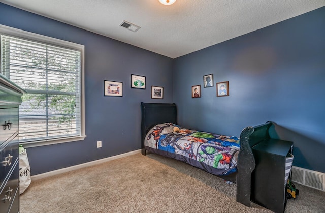 carpeted bedroom with a textured ceiling