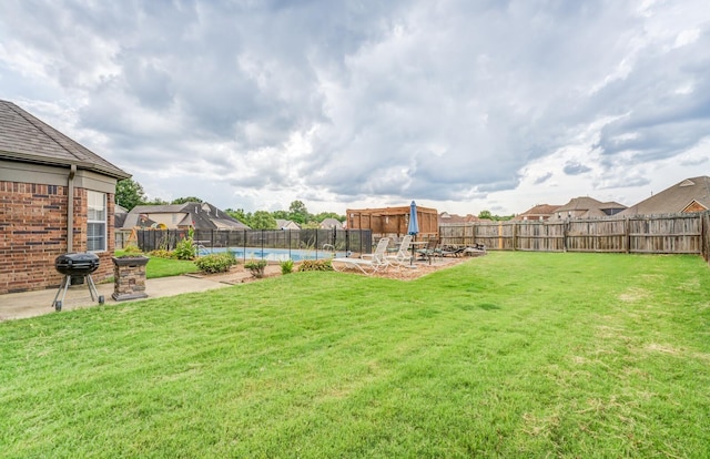 view of yard with a swimming pool and a patio