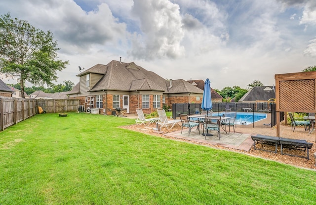 exterior space featuring a fenced in pool and a patio area