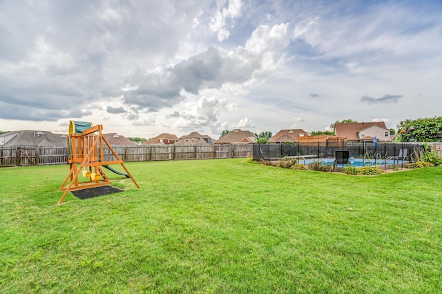 view of yard featuring a playground and a pool