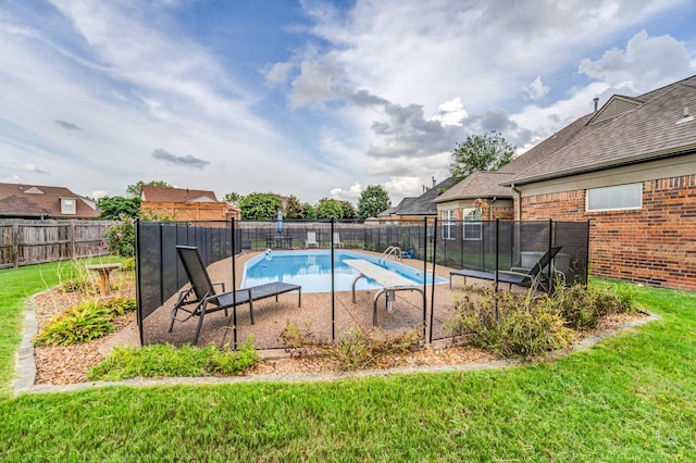 view of swimming pool with a lawn