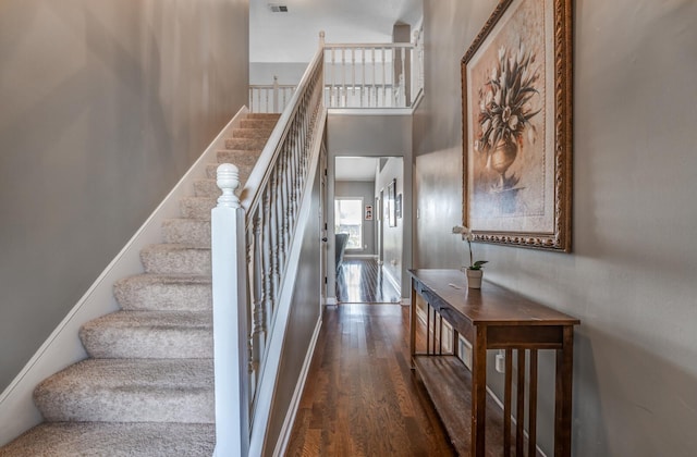 staircase with hardwood / wood-style floors