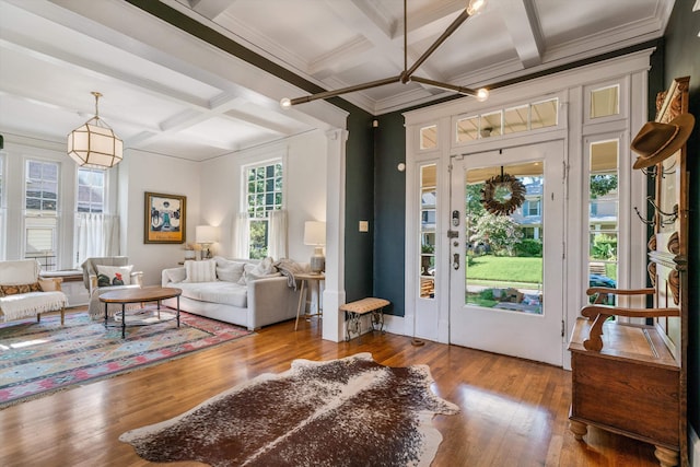 interior space with coffered ceiling, beam ceiling, hardwood / wood-style flooring, and crown molding