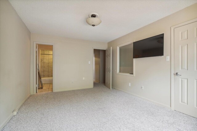 full bathroom featuring tile patterned flooring, tiled shower / bath combo, a textured ceiling, toilet, and vanity