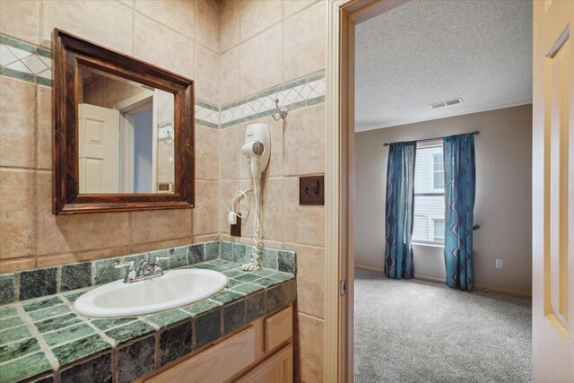 carpeted empty room with a textured ceiling