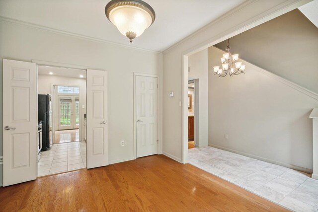 interior space with a chandelier, crown molding, and light hardwood / wood-style floors