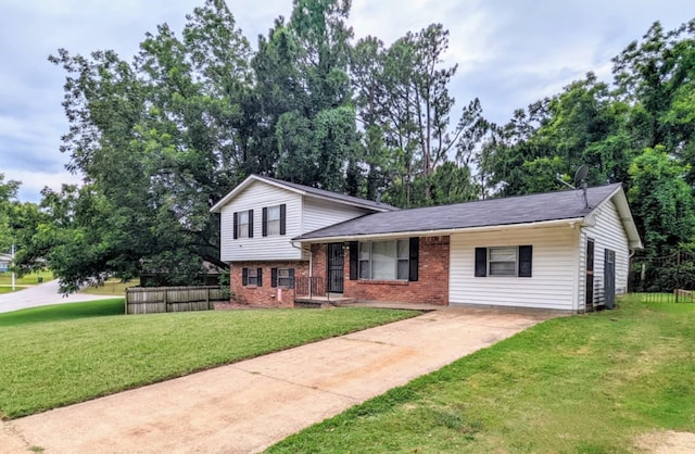 tri-level home featuring a porch and a front yard