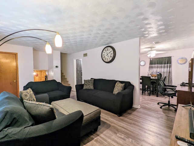 living room featuring hardwood / wood-style flooring and a textured ceiling