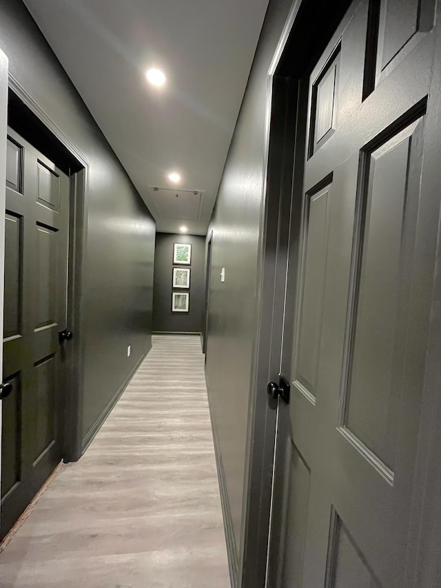 hallway with light hardwood / wood-style floors