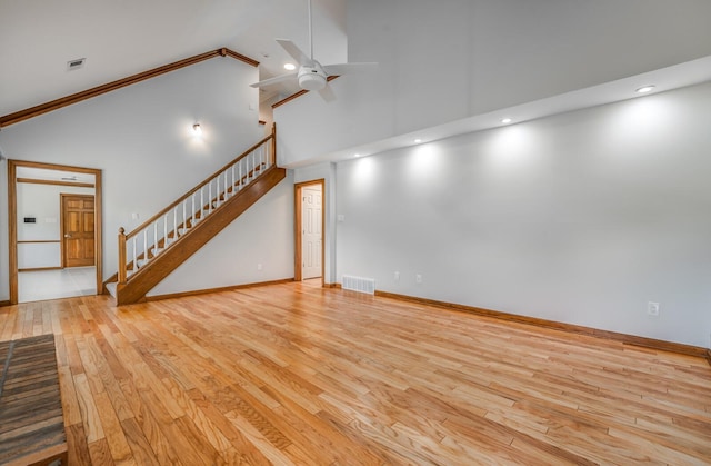 unfurnished living room featuring ceiling fan, light hardwood / wood-style floors, and high vaulted ceiling