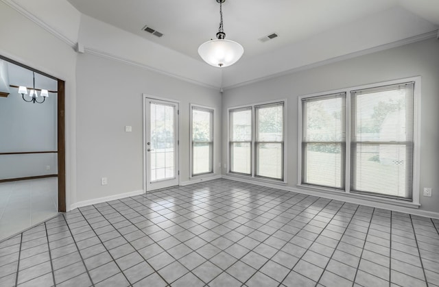 tiled empty room featuring an inviting chandelier, a healthy amount of sunlight, and a tray ceiling