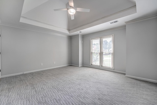 carpeted empty room with a raised ceiling, crown molding, and ceiling fan