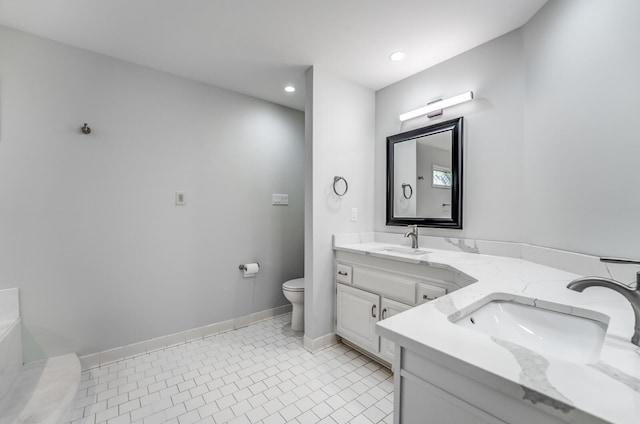 bathroom with tile patterned flooring, a bath, toilet, and double sink vanity