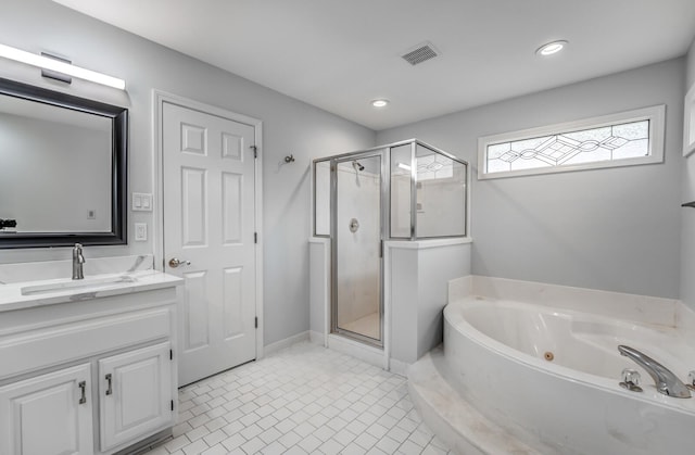 bathroom featuring plus walk in shower, vanity, and tile patterned floors